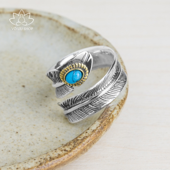 Silver ring formed as feather engraved turquoise